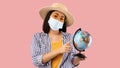 Sad Asian Woman Holding Globe, Wearing Face Mask Royalty Free Stock Photo