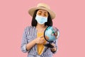 Sad Asian Woman Holding Globe, Wearing Protective Face Mask Royalty Free Stock Photo