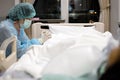 Sad asian woman or nurse in face mask and medical uniform pray with closed eyes hands clasped together say a prayer for senior Royalty Free Stock Photo