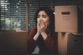 Sad Asian woman Packing belongings in a cardboard box and crying on the desk in the office After being layoff and unemployed.