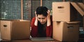 Sad Asian woman Packing belongings in a cardboard box and crying on the desk in the office After being layoff and unemployed.