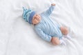 Sad baby boy on the bed crying lying on his back Royalty Free Stock Photo