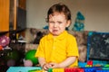 Sad baby boy crying next to toys Royalty Free Stock Photo