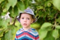 Sad baby boy standing in the summer garden Royalty Free Stock Photo