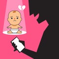 A sad baby and a person playing with their smartphone