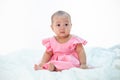 Sad baby on a white bed Royalty Free Stock Photo