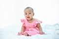 Sad baby on a white bed Royalty Free Stock Photo