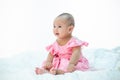 Sad baby on a white bed Royalty Free Stock Photo