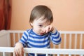 Sad baby in white bed Royalty Free Stock Photo