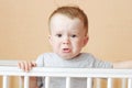 Sad baby in white bed Royalty Free Stock Photo