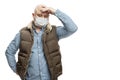 Sad bald adult man in a medical mask stands holding his head with his hand. Precautions quarantined for the period of the Royalty Free Stock Photo