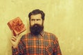 Sad bearded man with red gift box with bow Royalty Free Stock Photo