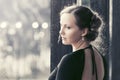 Sad beautiful fashion woman in black dress in a city street Royalty Free Stock Photo