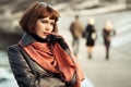 Sad beautiful fashion woman in leather coat walking in city street Royalty Free Stock Photo