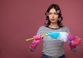 Sad beautiful girl in curlers does not want to clean up