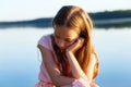 Sad Beautiful teen girl is looking with serious face at seaside Royalty Free Stock Photo