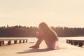 Sad Beautiful teen girl is sitting with serious face at seaside Royalty Free Stock Photo