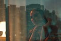 Sad beautiful woman sitting next to a window Royalty Free Stock Photo