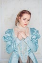 Sad Beautiful young woman in medieval style blue dress Royalty Free Stock Photo