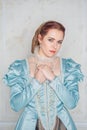 Sad Beautiful young woman in medieval style blue dress Royalty Free Stock Photo