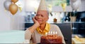 Sad, birthday and senior woman thinking with depression, grief and lonely in her home. Cake, face and elderly African Royalty Free Stock Photo