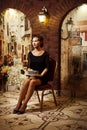 sad birthday, a young woman with a displeased face sits on a chair holding a cake