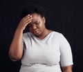 Sad black woman, headache and stress in studio of anxiety, trauma risk and worry on dark background. Frustrated Royalty Free Stock Photo