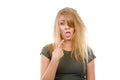 Sad blonde woman with messy hair pointing tongue Royalty Free Stock Photo