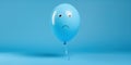 Sad blue balloon with sad emoji, on a blue background, blue monday, copy space, banner