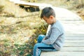 Sad and bored boy 5-6 years old in a city park Royalty Free Stock Photo