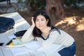 Sad and bored girl student lying in a pile of books Royalty Free Stock Photo