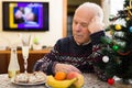 Sad older man celebrating New Year alone during pandemic Royalty Free Stock Photo