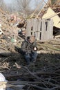 Sad boy amidst tornado wreckage