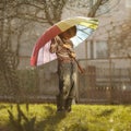 Sad boy with colorful rainbow umbrella Royalty Free Stock Photo