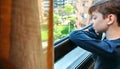 Boy in coronavirus lockdown looking through the window Royalty Free Stock Photo