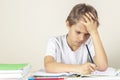 Sad boy doing homework. Education, school, learning difficulties concept Royalty Free Stock Photo