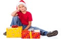 Sad boy with gift box in christmas hat Royalty Free Stock Photo