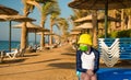 Sad boy in green mask on empty beach line Royalty Free Stock Photo