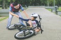 Sad boy helped by his father after falling from a bike Royalty Free Stock Photo