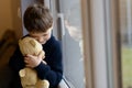 Sad boy is hugging his teddy bear. Royalty Free Stock Photo