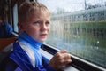 SAD BOY LOOKS IN WINDOW Royalty Free Stock Photo