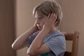 Sad boy plugging ears Royalty Free Stock Photo