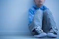 Sad boy sits alone Royalty Free Stock Photo