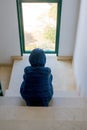 Sad boy sitting alone on the staircase Royalty Free Stock Photo