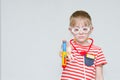 Sad boy with a toy syringe in glasses Royalty Free Stock Photo