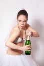 Sad bride with a bottle of champagne in hand Royalty Free Stock Photo