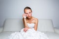 Sad bride crying sitting on a sofa Royalty Free Stock Photo