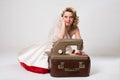 Sad bride with retro sewing machine sitting in studio Royalty Free Stock Photo