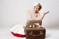 Sad bride with retro sewing machine sitting in studio Royalty Free Stock Photo