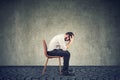 Sad broke businessman sitting in an empty office Royalty Free Stock Photo